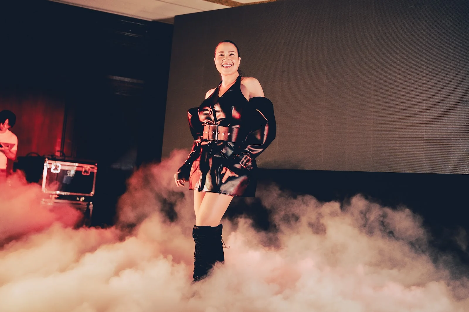 Tata Young on stage surrounded by theatrical smoke